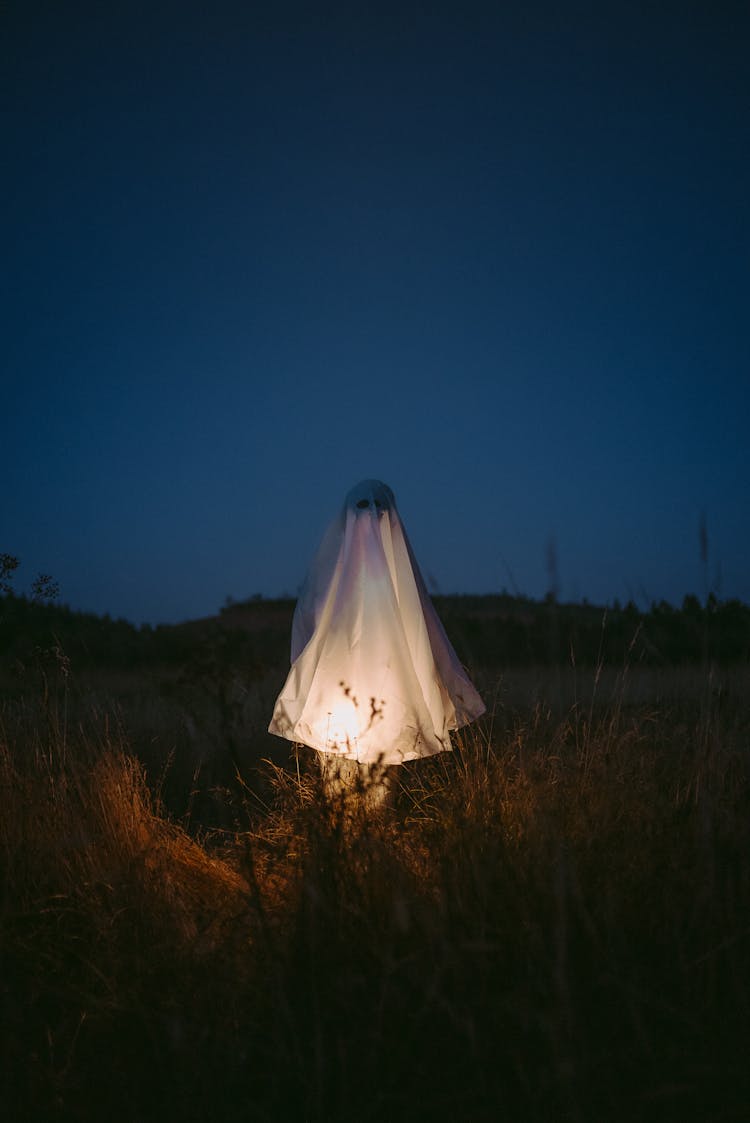 Ghost On The Grass Field During Night Time