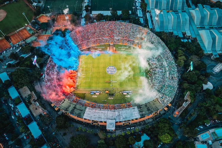 Aerial View Of Stadium With Blue And Red Smoke