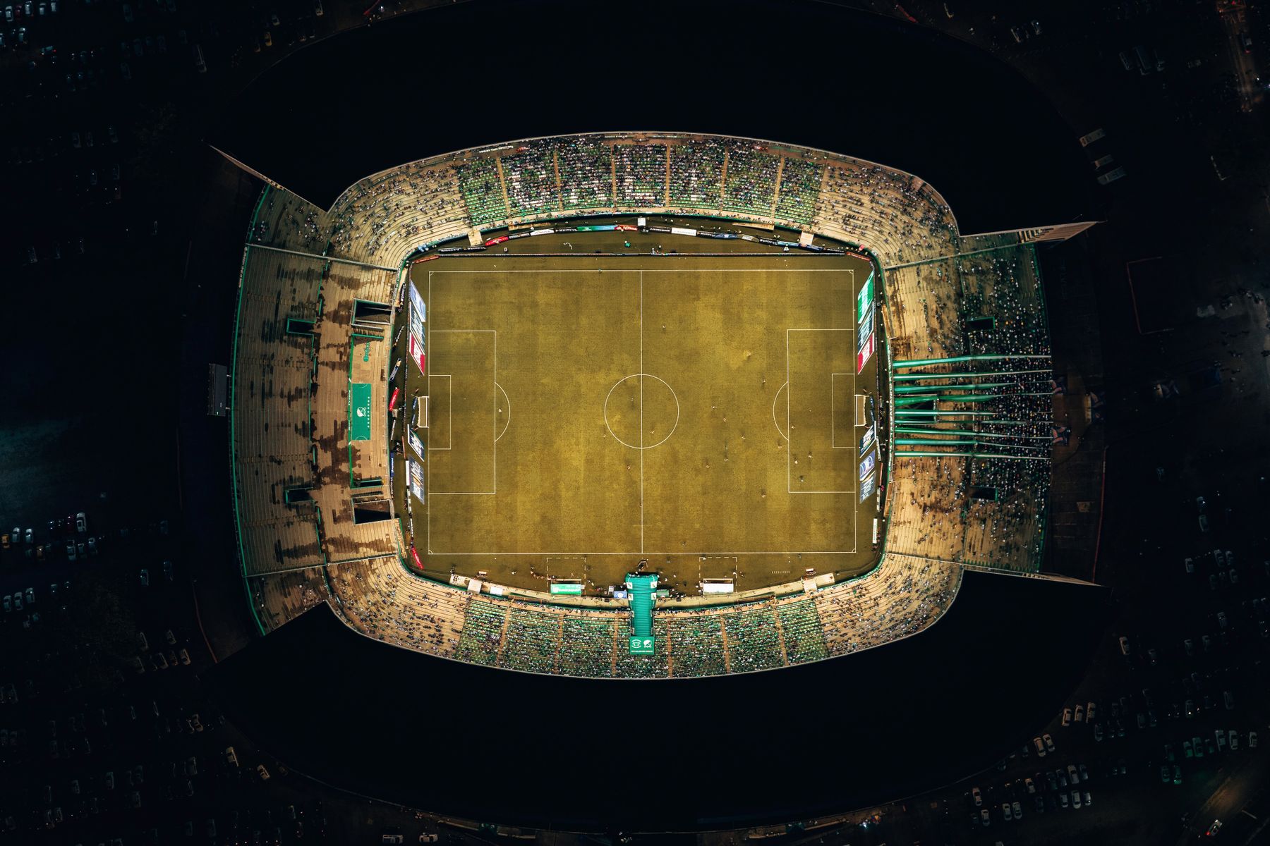 Packed football stadium at night seen from above