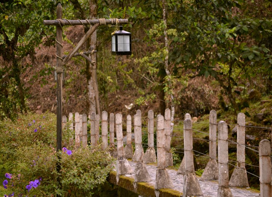 Rustic bridge and lamp post in Santa Rosa de Cabal, Colombia forest.