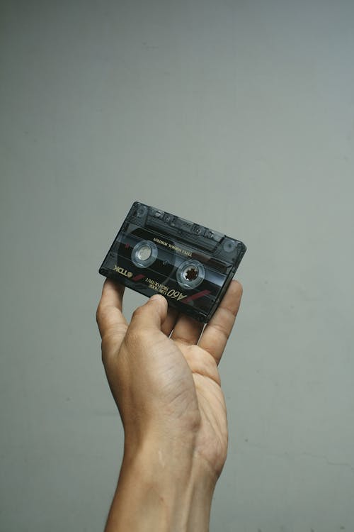 A Person Holding a C0assette Tape