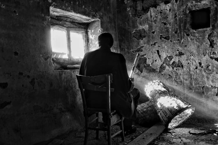 Man Sitting In Dreary Room