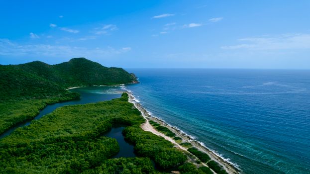 A stunning aerial view of the Caribbean coastline in Carabobo, Venezuela, showcasing lush greenery and turquoise waters.