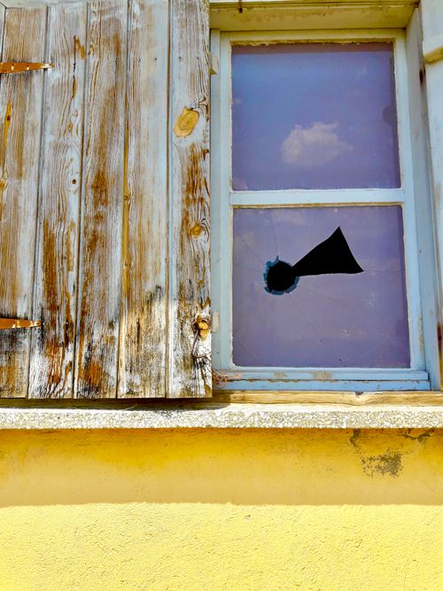 Free Close-up of a broken glass window with wooden shudders in Denizli, Turkey. Stock Photo