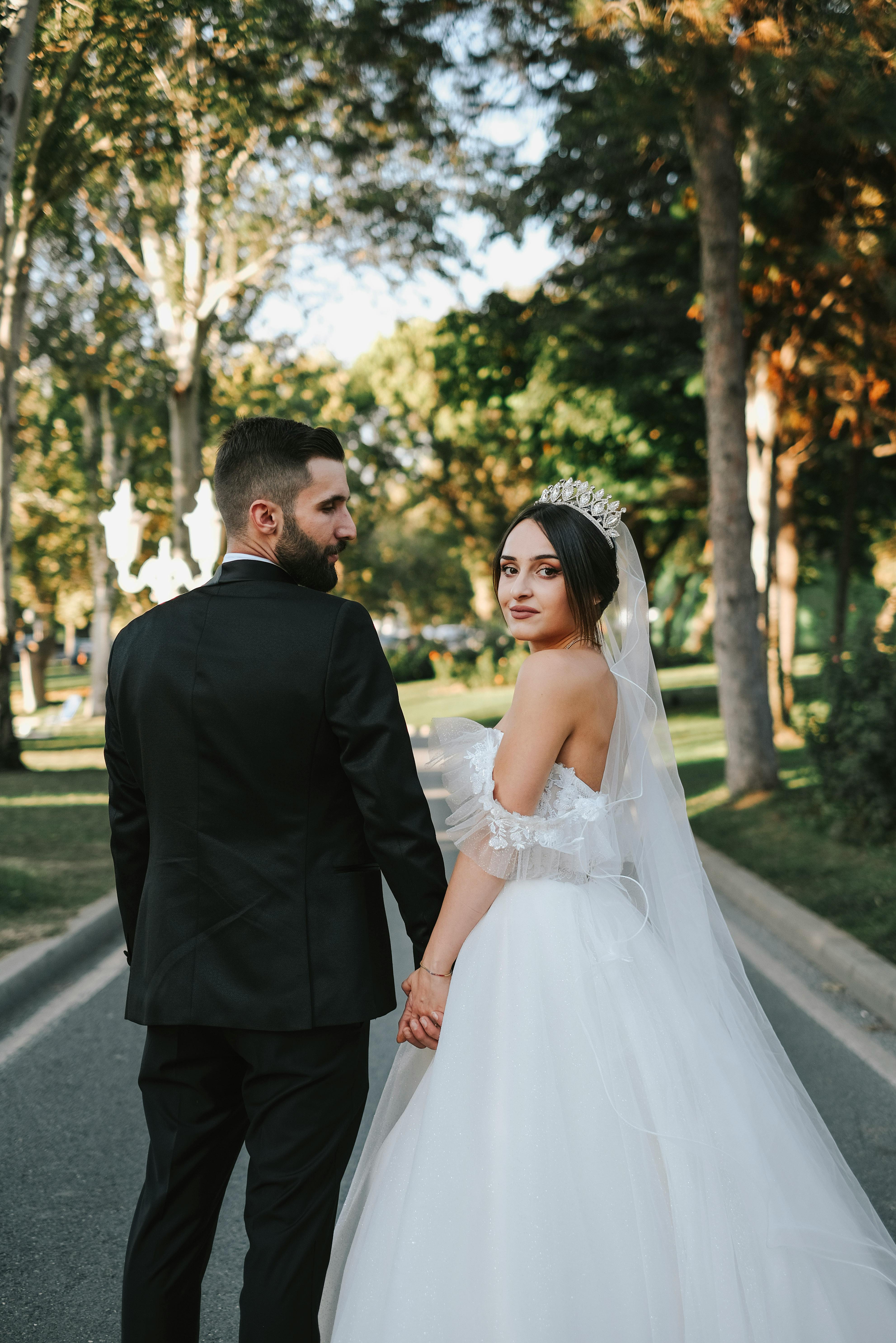 newlyweds holding hands and looking back