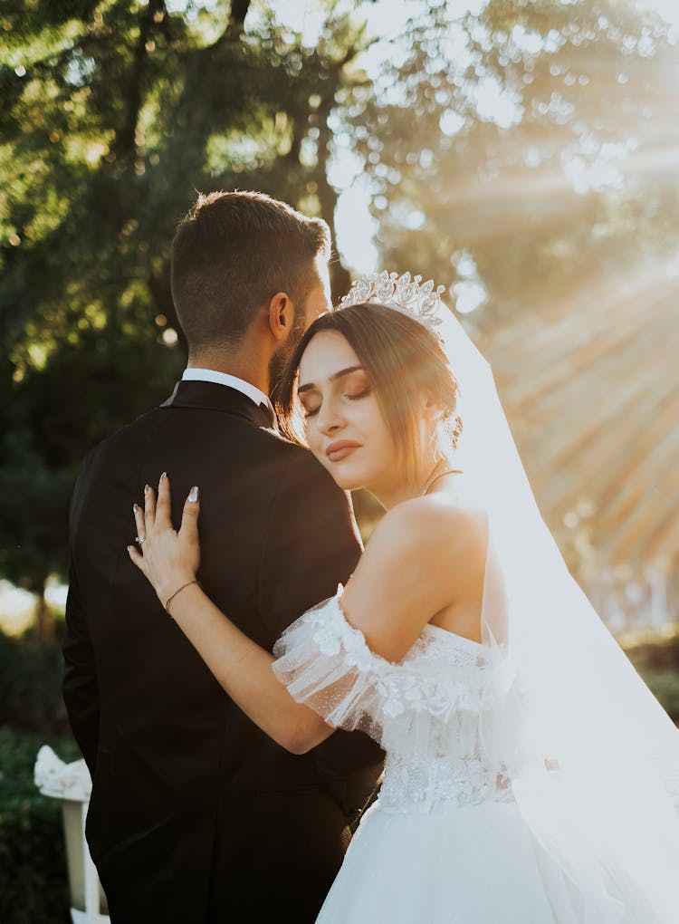 Newlyweds Hugging In Sunlight