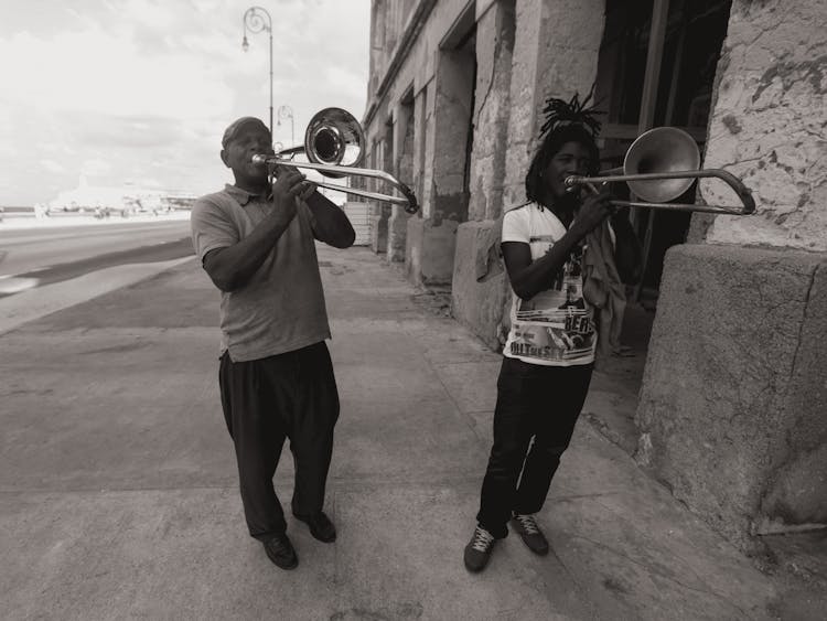 Men Playing Trumpets On The Street 