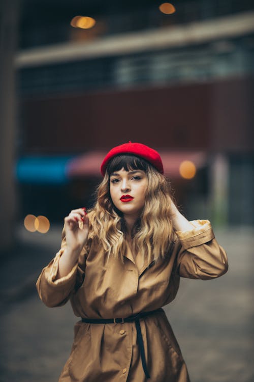 Young Woman in a Red Beret Fixing her Hair 