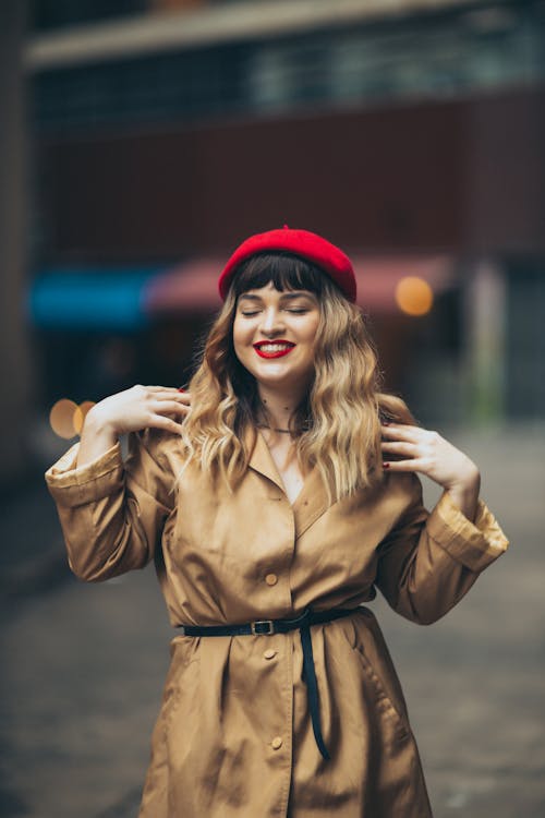 Attractive Young Woman in a Red Beret and a Trench Coat 