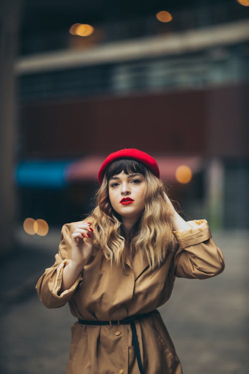 Beautiful Young Woman in a Red Beret with her Hand in her Hair 