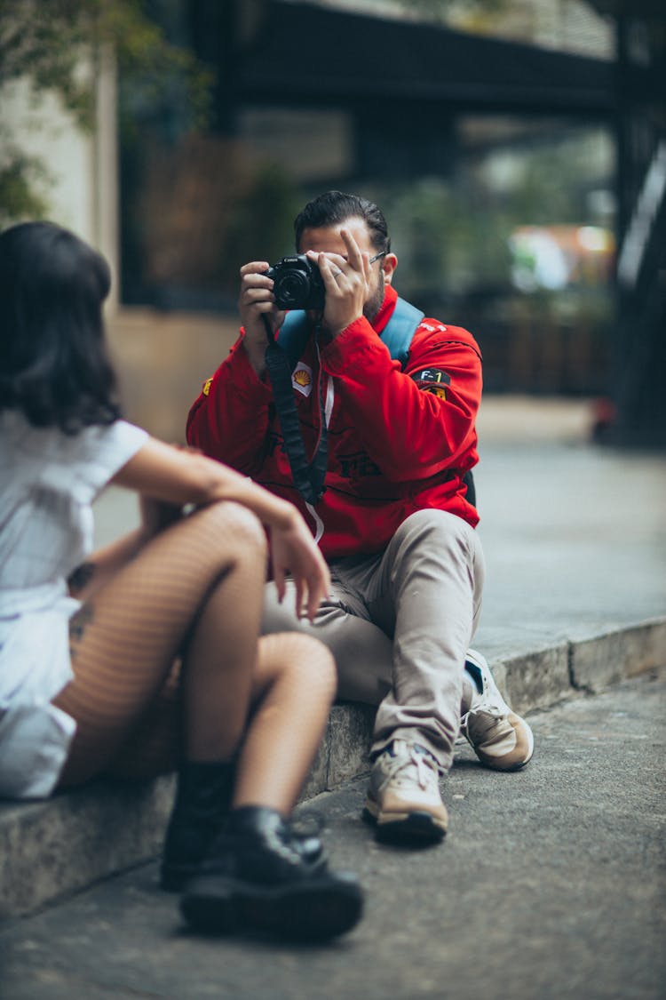 A Photographer Taking A Picture Of A Woman