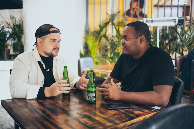 Men Sitting In Restaurant Drinking Beer