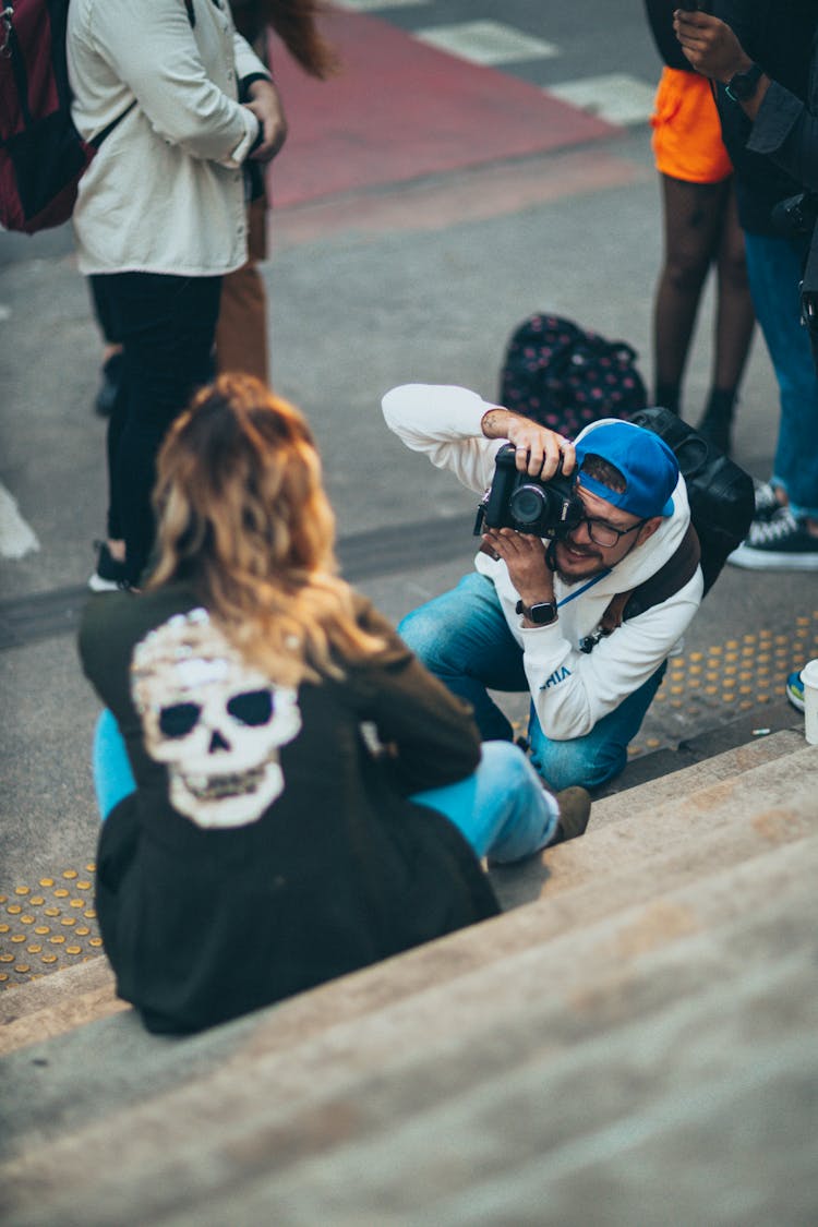 A Photographer Taking A Picture In A City