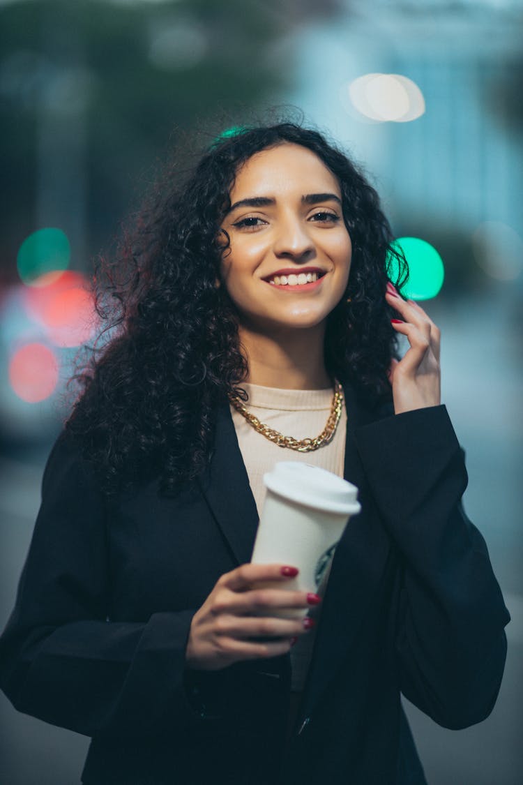 Portrait Of Smiling Woman With Cup Of Takeout Coffee