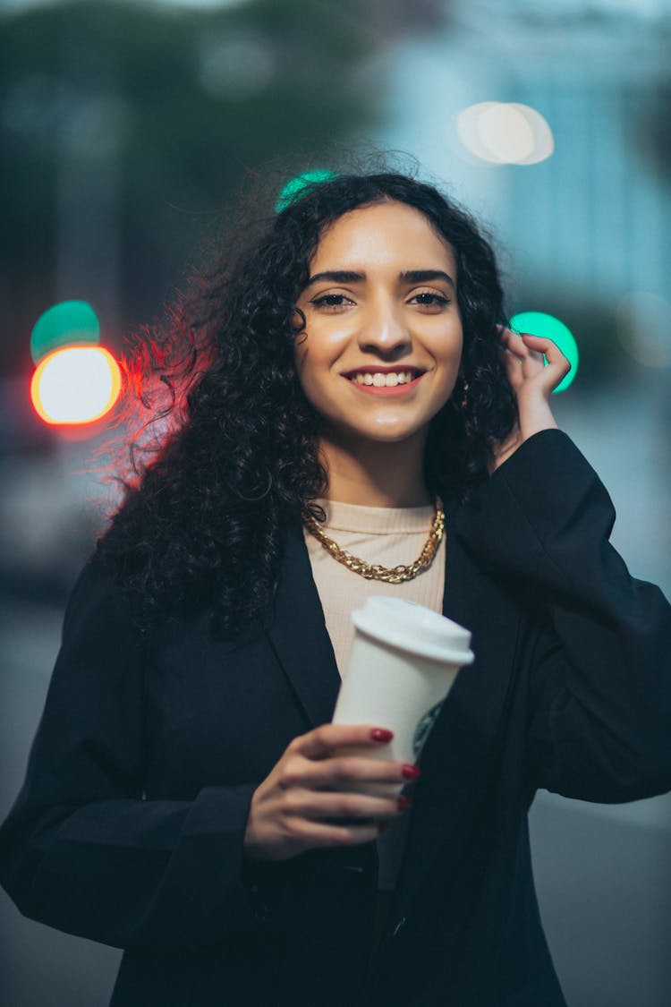 Portrait Of Smiling Woman With Takeout Coffee