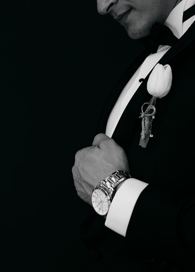 Black And White Photo Of Man Wearing Watch And Tulip In Boutonniere 