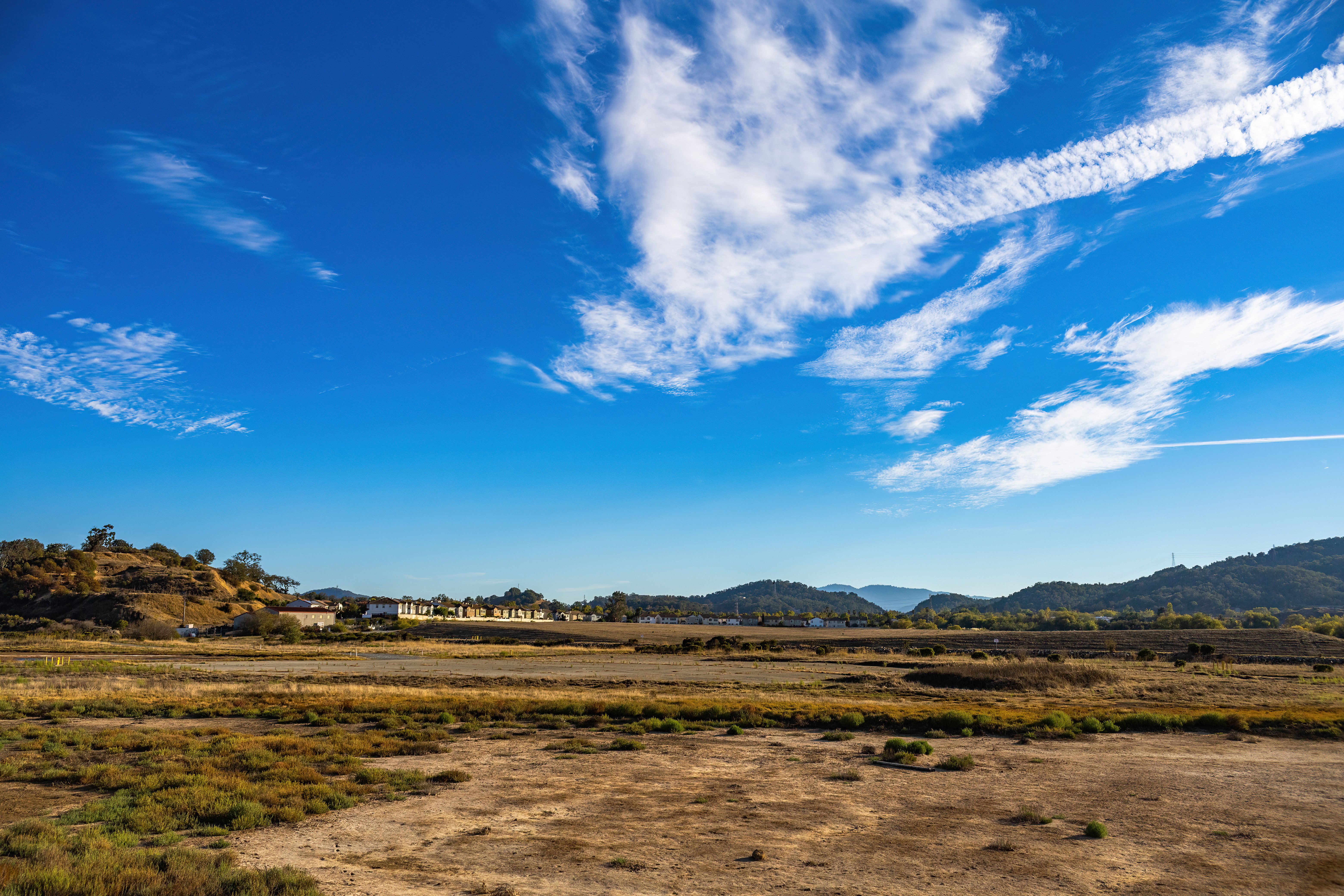 Brown Grass Field Under Blue Sky and White Clouds · Free Stock Photo