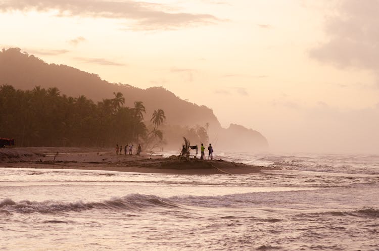 People Fishing On Sea Shore