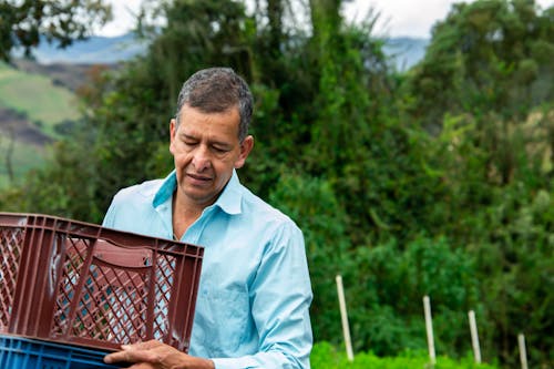 Man Carrying Plastic Crates