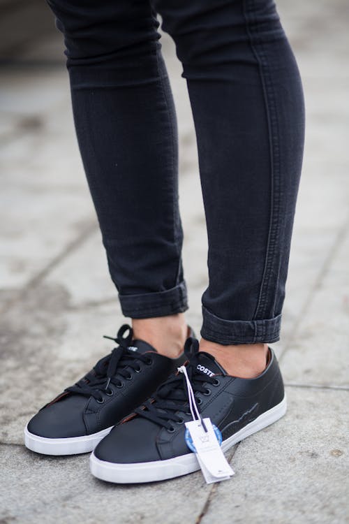 Free Person Wearing Black Pants And Pair Of Black Sneakers Stock Photo