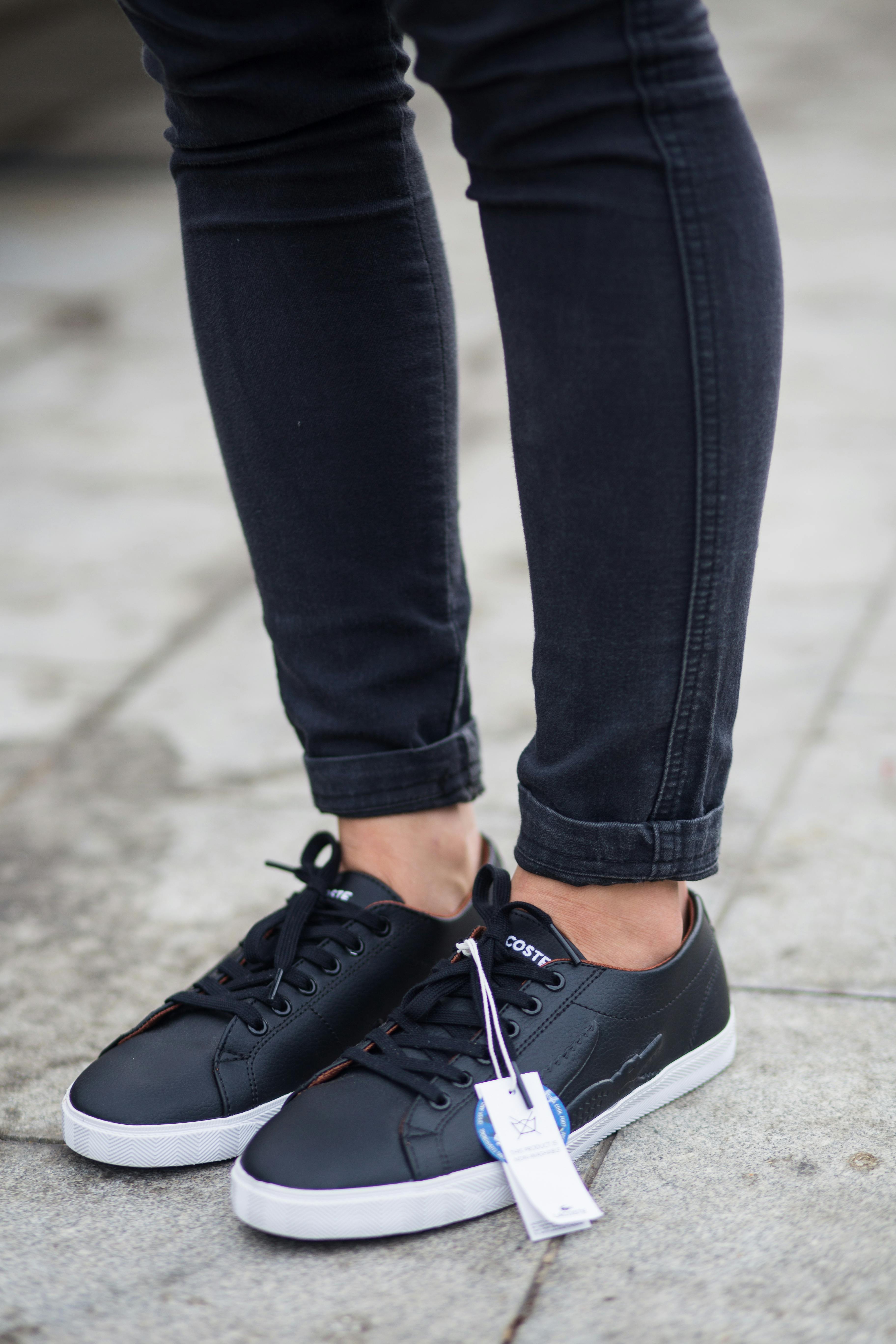Person Wearing Black Pants And Pair Of Black Sneakers · Free Stock Photo