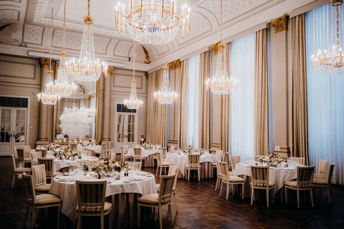 Ballroom laid for a gala under crystal chandeliers — photo by Rene Terp on Pexels