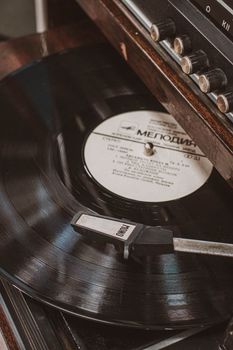 A vintage vinyl record spinning on a classic turntable capturing the nostalgia of analog music.