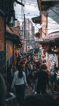 Vibrant street scene in Bogotá, Colombia showcasing a lively alley with people amidst urban architecture.