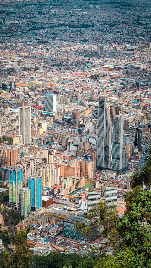 Free Aerial view of Bogotá's cityscape highlighting modern skyscrapers and urban sprawl in Colombia. Stock Photo