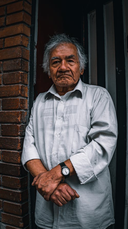 Elderly Man Standing at the Doorway