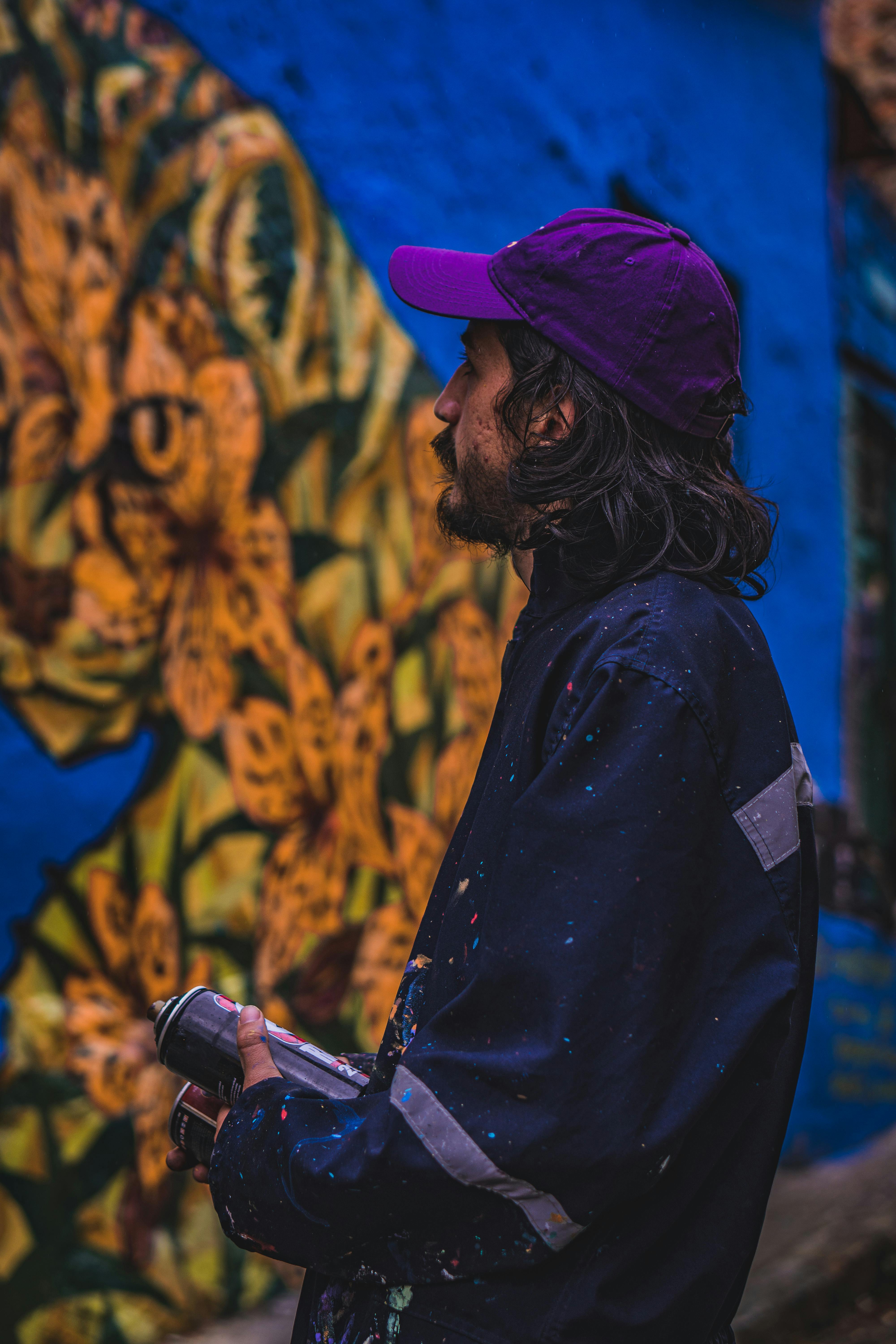 Man in Blue Jacket Holding Spray Paints · Free Stock Photo