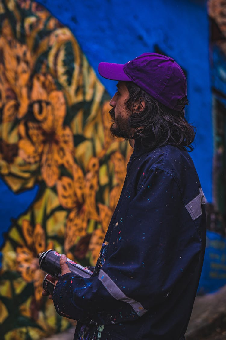 Man In Blue Jacket Holding Spray Paints