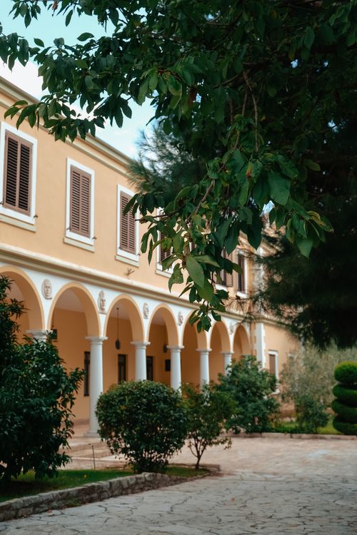Free Charming Mediterranean architecture with arches and lush garden in daylight. Stock Photo