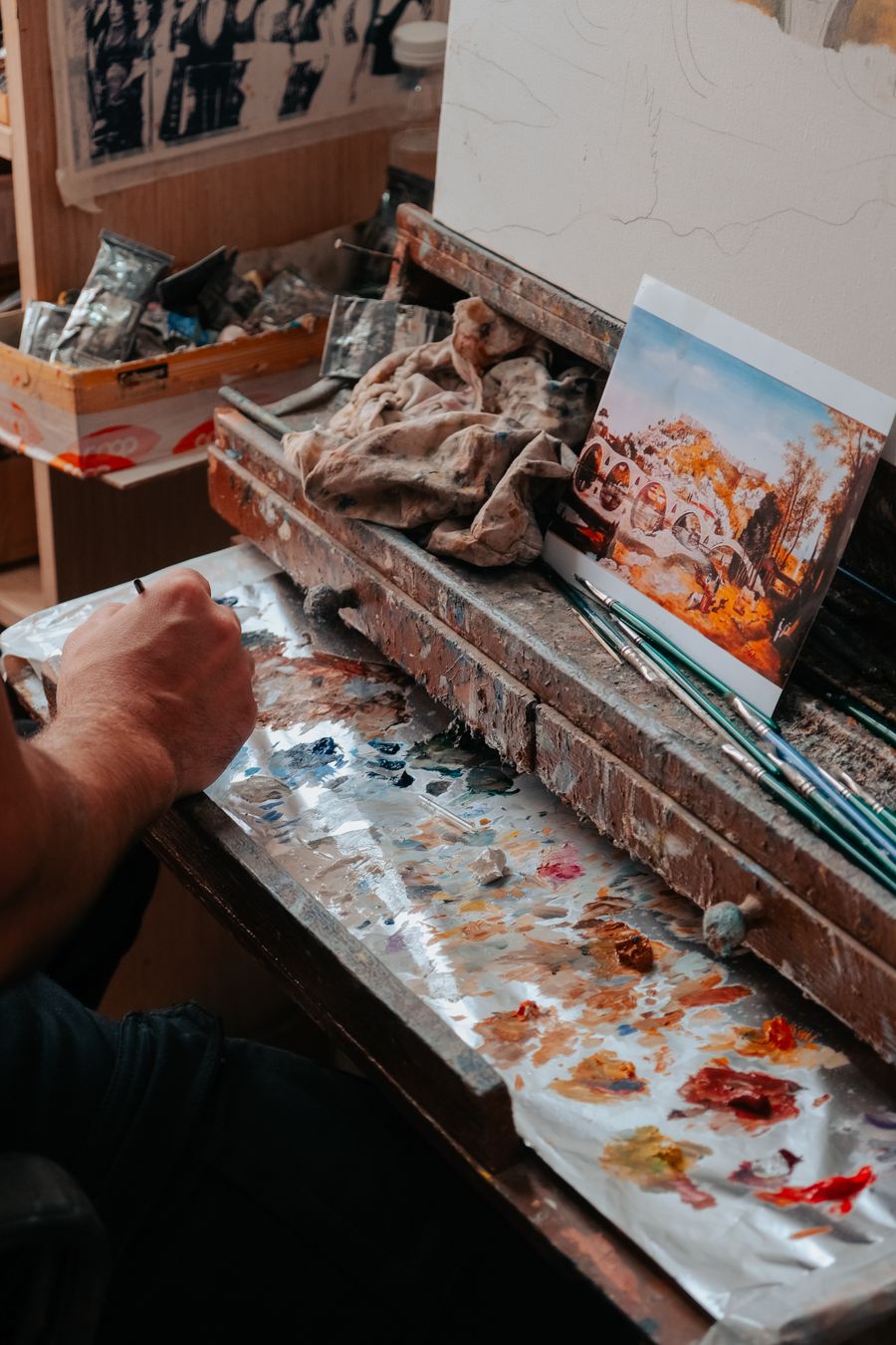Artist preparing to paint in a rustic studio