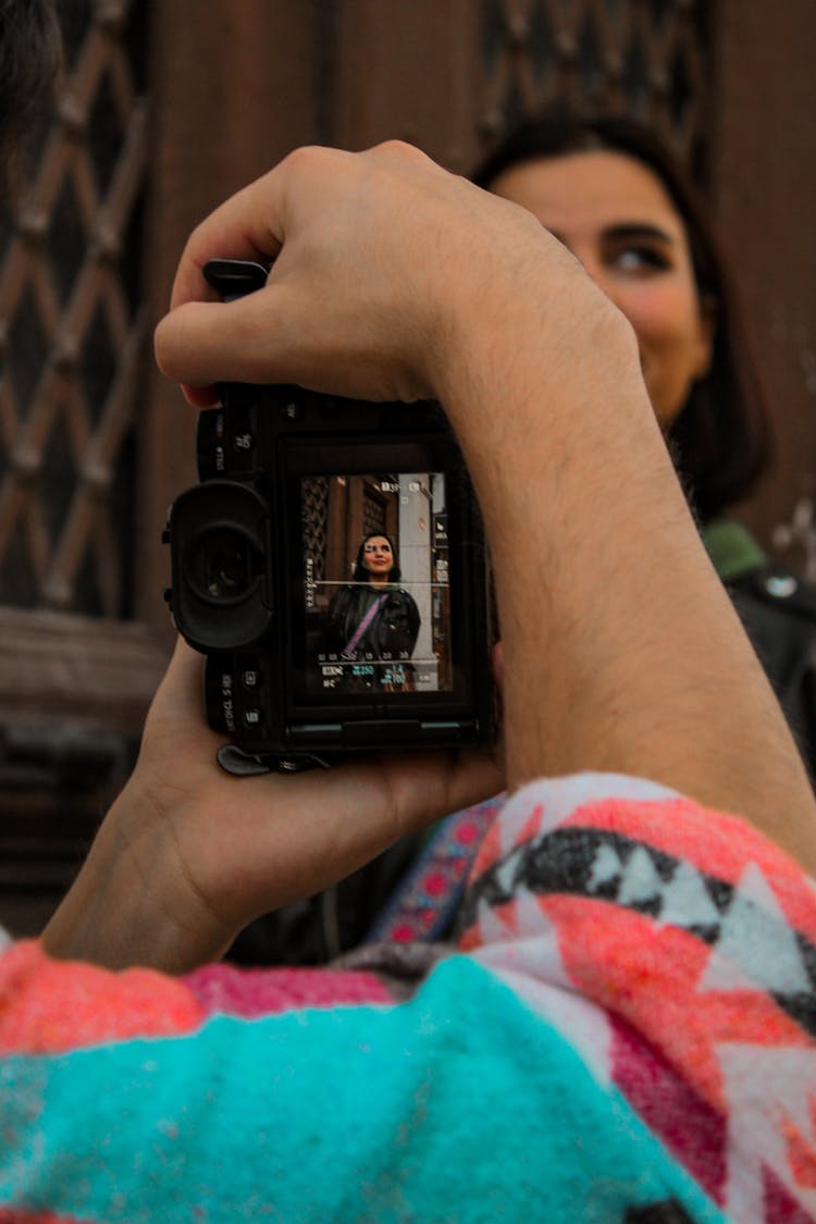 A Person Taking A Picture With A Camera