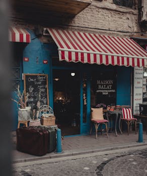 Vintage cafe with striped awning in Istanbul's Balat neighborhood. Cozy and inviting atmosphere.