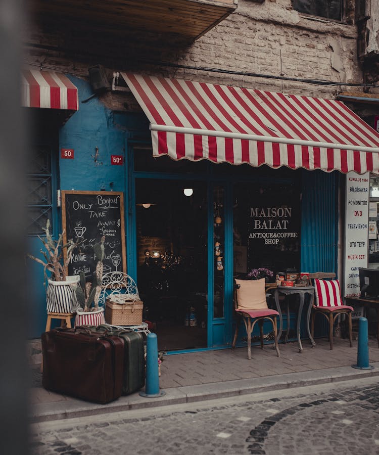 A Store With A Striped Awning