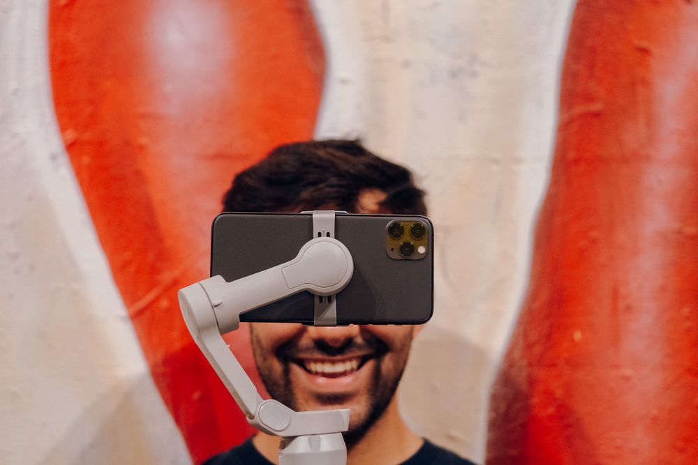 Young creator filming himself on a phone gimbal