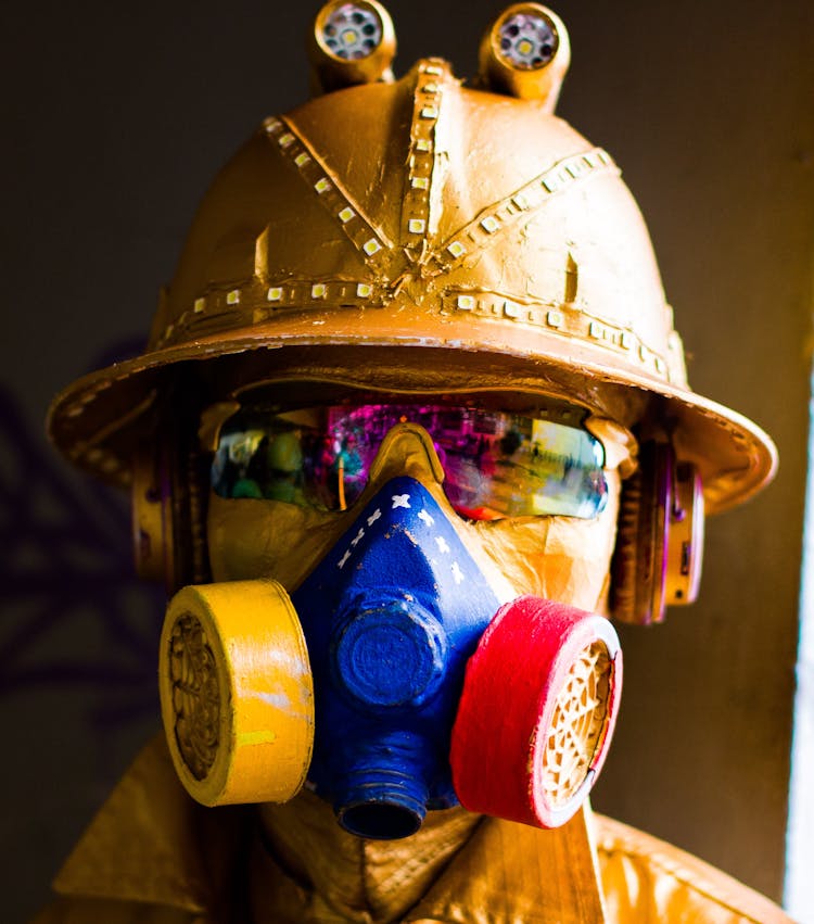 Yellow Statue Wearing Helmet, Gas Mask, And Sunglasses