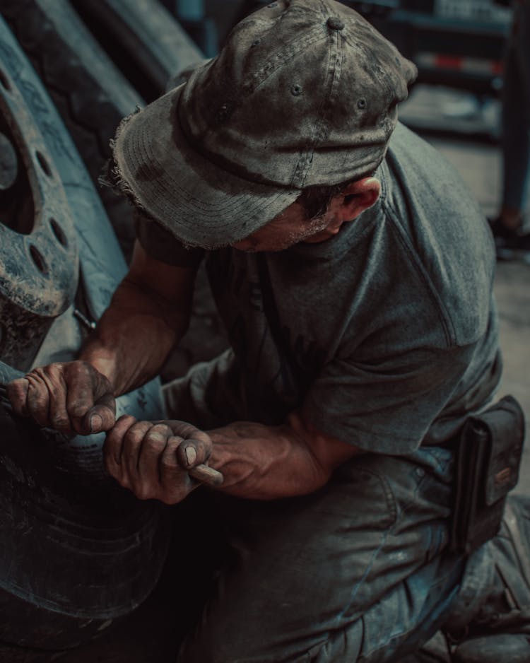 Man Fixing A Tire