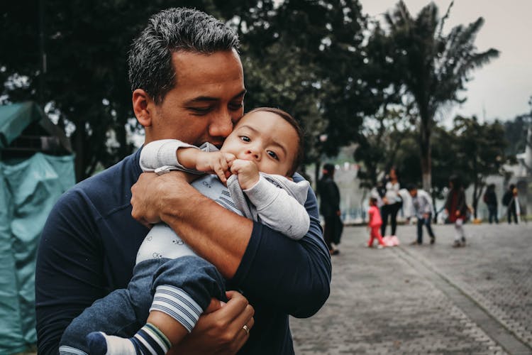 Man Carrying A Baby