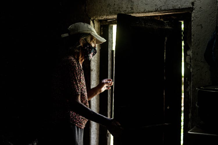 Photo Of An Elderly Woman Going Out A Door