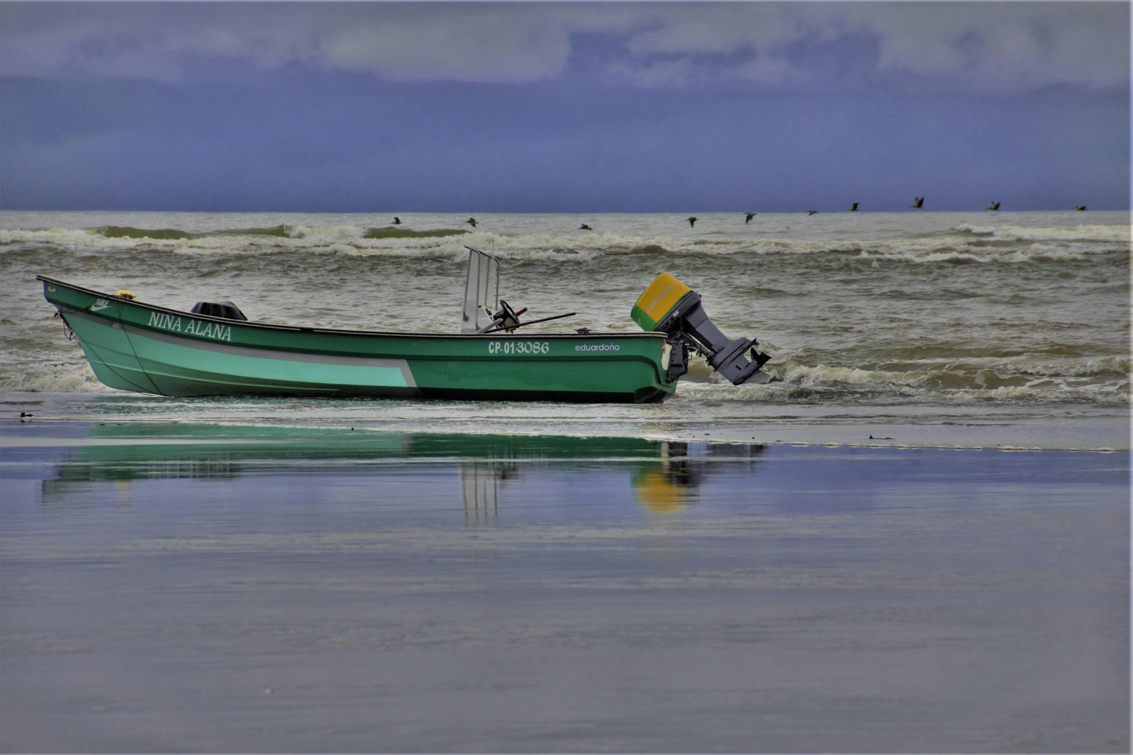 Green Fishing Boat on Seashore · Free Stock Photo
