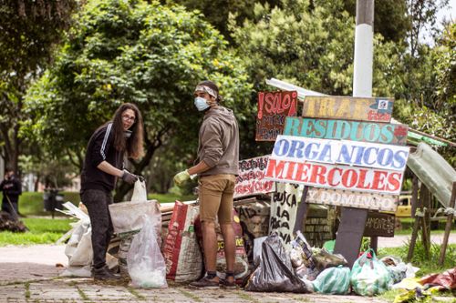 Free Two volunteers clean a park in Bogotá, Colombia, promoting environmental sustainability. Stock Photo