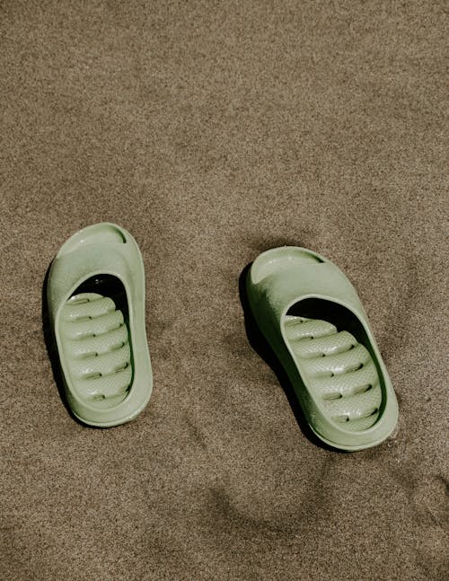 Green Slides on Brown Beach Sand