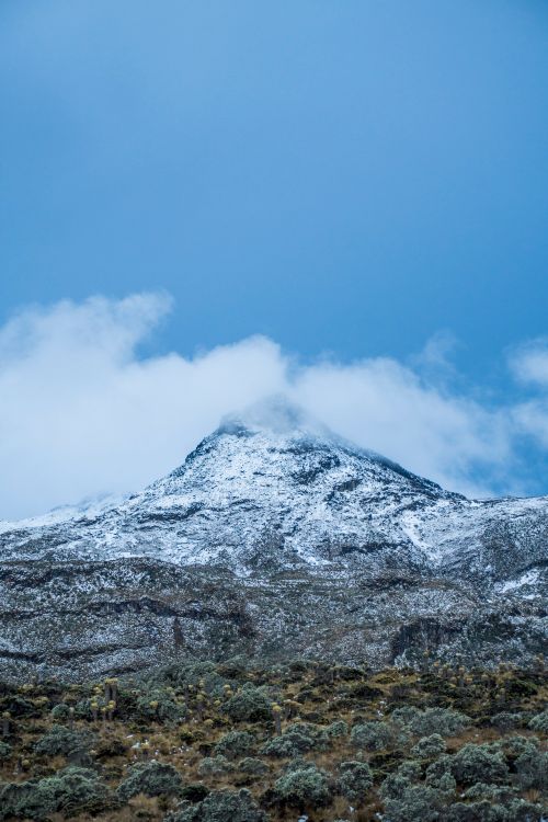 Free Breathtaking snowy mountain peak beneath a bright blue sky, evoking a sense of adventure and tranquility. Stock Photo