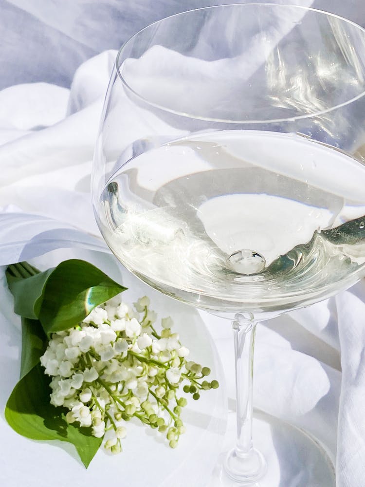 Clear Wine Glass On White Textile