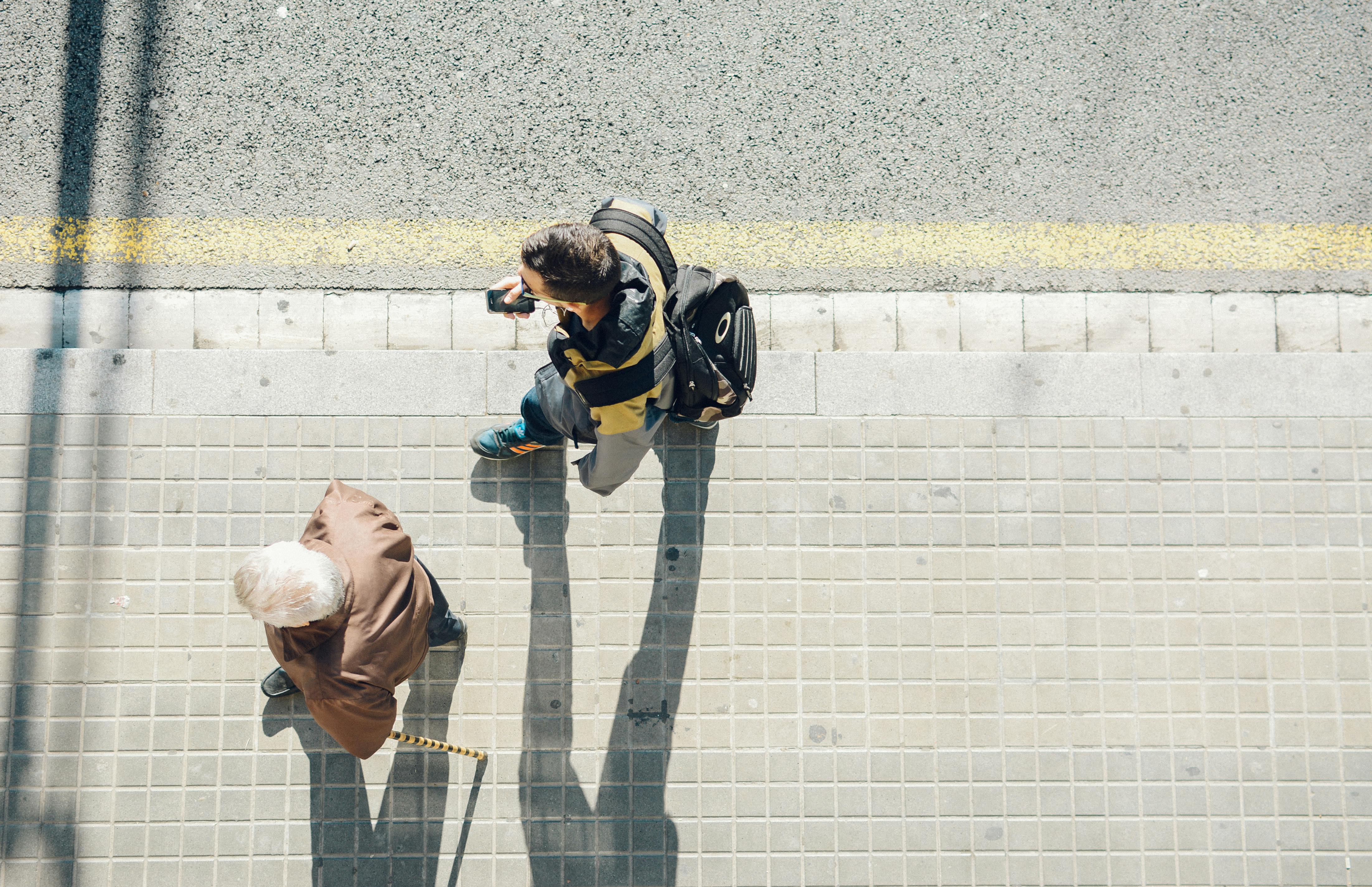 Two people walking along the street on a workday morning