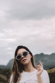 Young woman in checkered sunglasses enjoying a relaxed outdoor day.