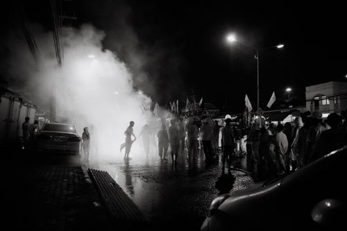 Free Captivating nighttime parade in Phuket, Thailand with people and smoke. Stock Photo